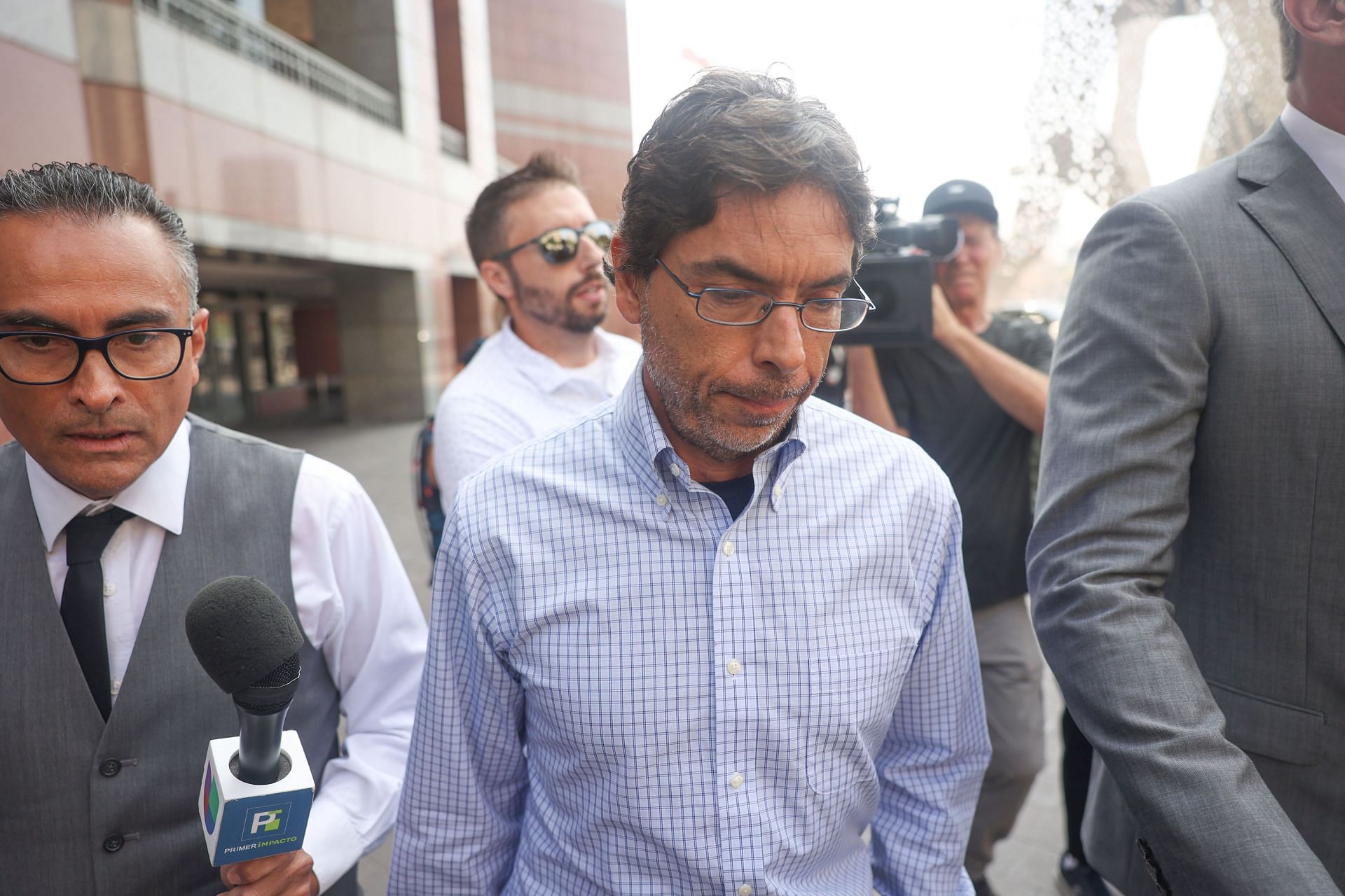 Chavez, one of the doctors charged in connection with the death of Matthew Perry, is swarmed by the media. (Image via Getty)